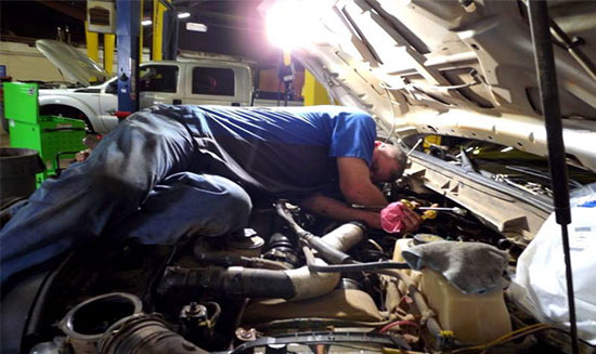 Roy working on diesel truck.